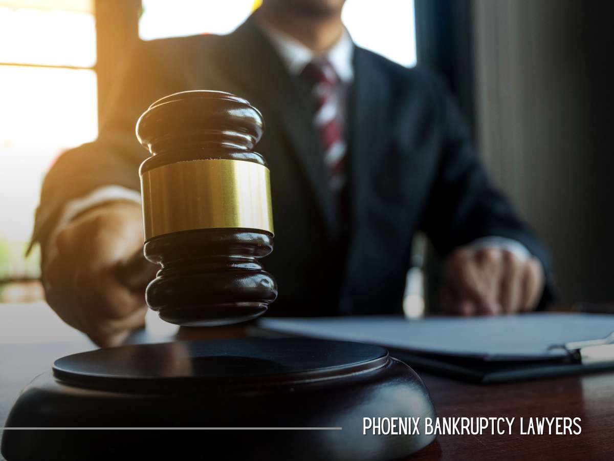 A gavel on a desk with a blurred lawyer behind it, representing legal action related to bankruptcy